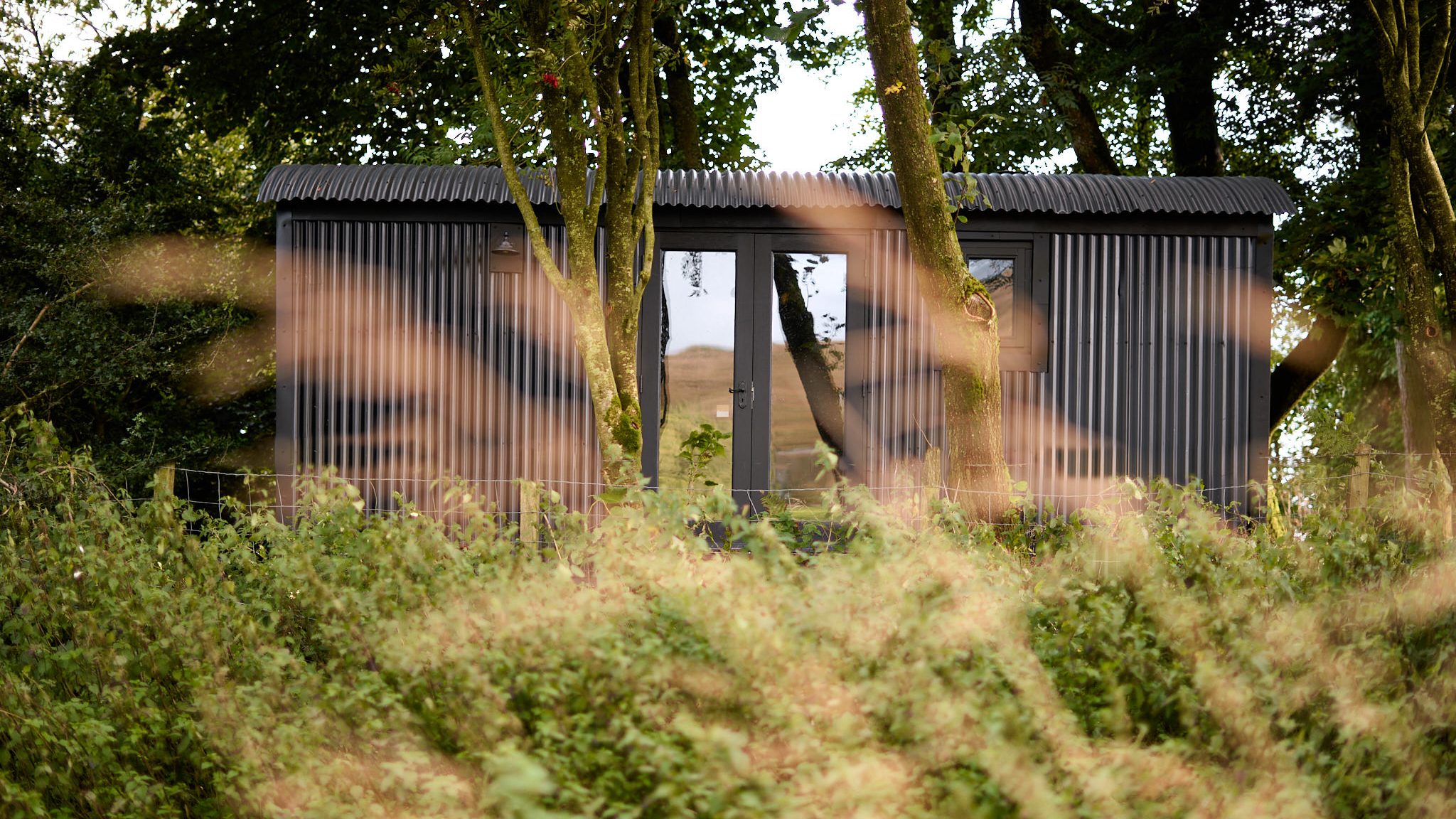exterior of Shepards hut amongst the trees