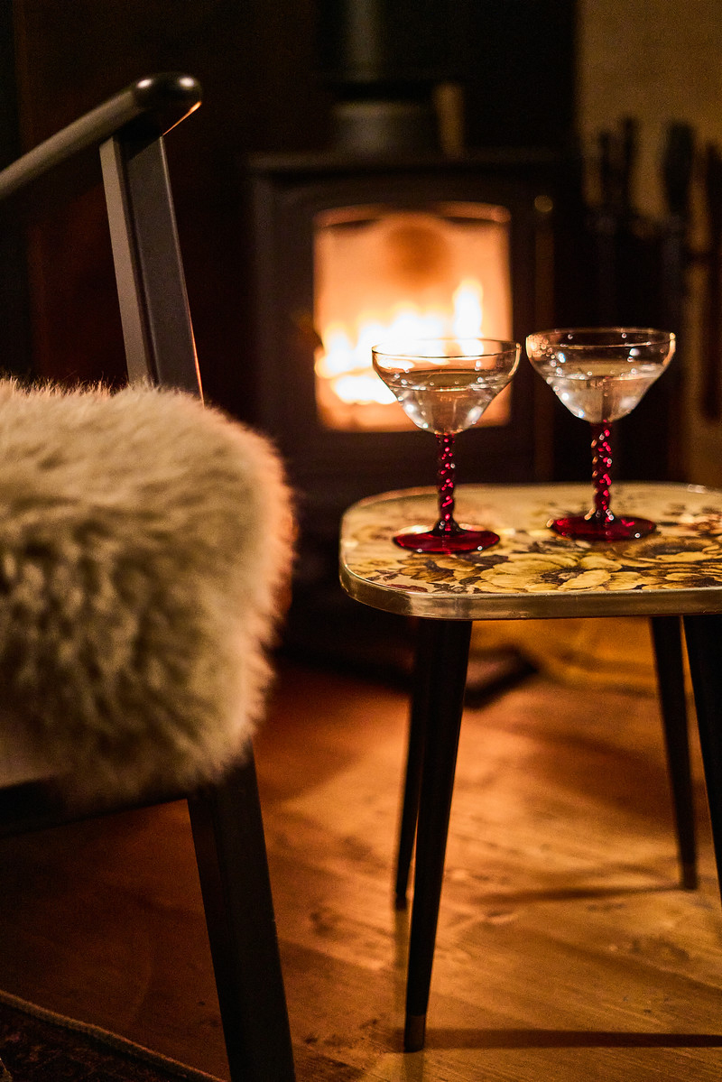 Log fire with drinks on a table