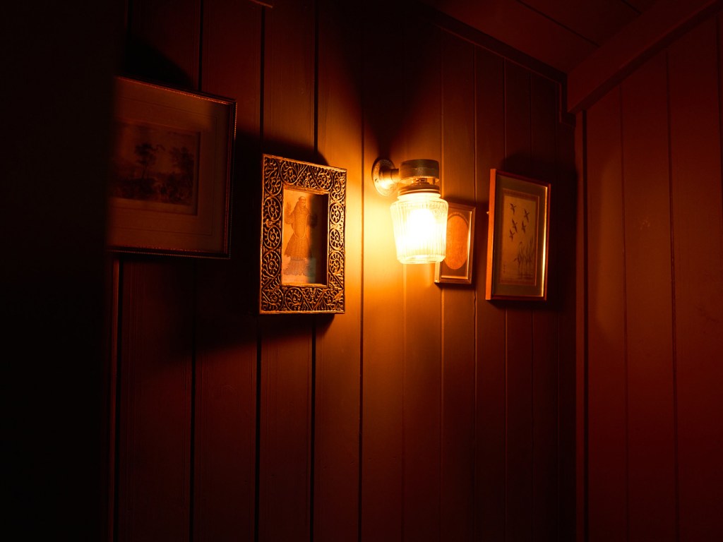 Shepards Hut wall with light and picture frames